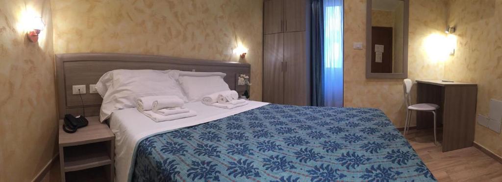 A bed or beds in a room at Hotel Orchidea