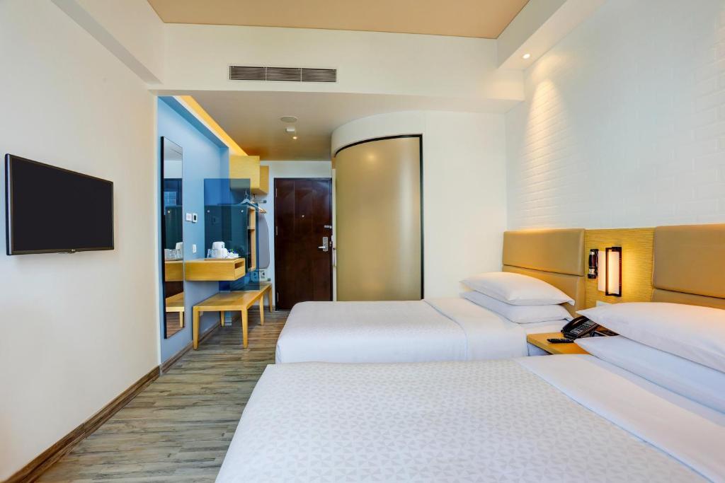 Postel nebo postele na pokoji v ubytování Four Points by Sheraton Chennai OMR