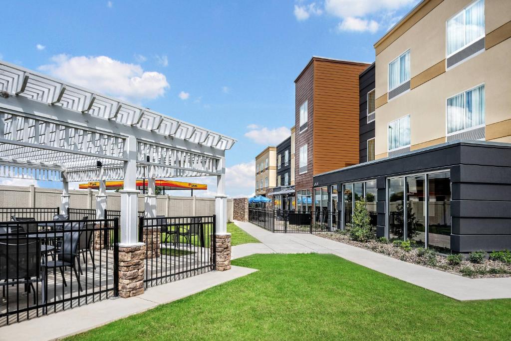 an exterior view of a building with a patio and grass at Fairfield Inn & Suites by Marriott Van in Van