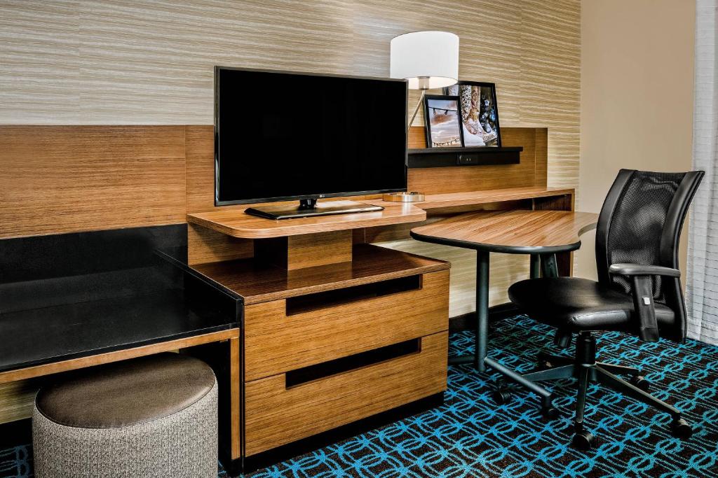 a hotel room with a desk with a monitor and a chair at Fairfield Inn & Suites by Marriott Van in Van