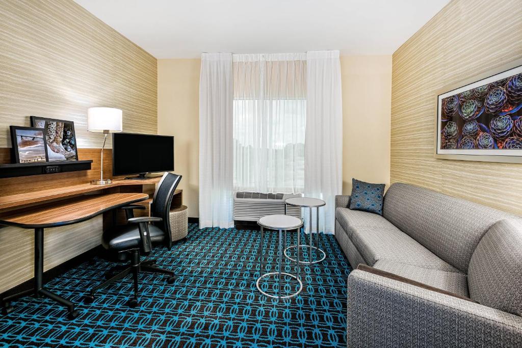 a hotel room with a couch and a desk at Fairfield Inn & Suites by Marriott Van in Van