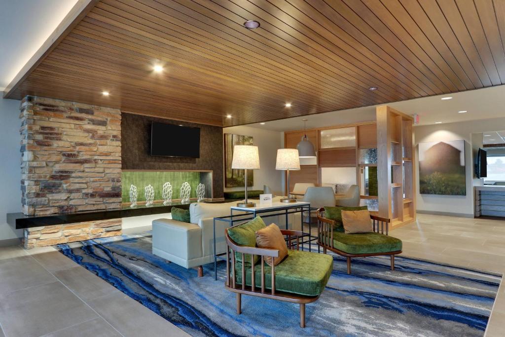 a lobby with a living room with a table and chairs at Fairfield Inn & Suites Warsaw in Warsaw
