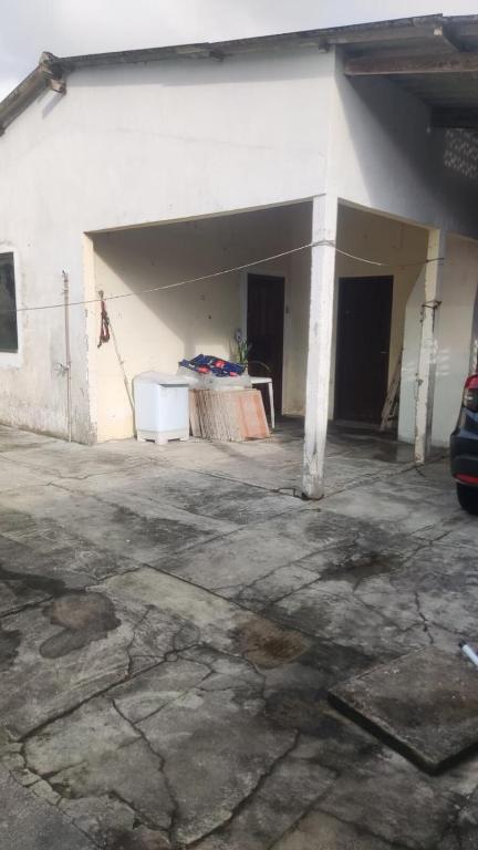 a white building with a table in front of it at House beach da Nay in Pontal do Paraná
