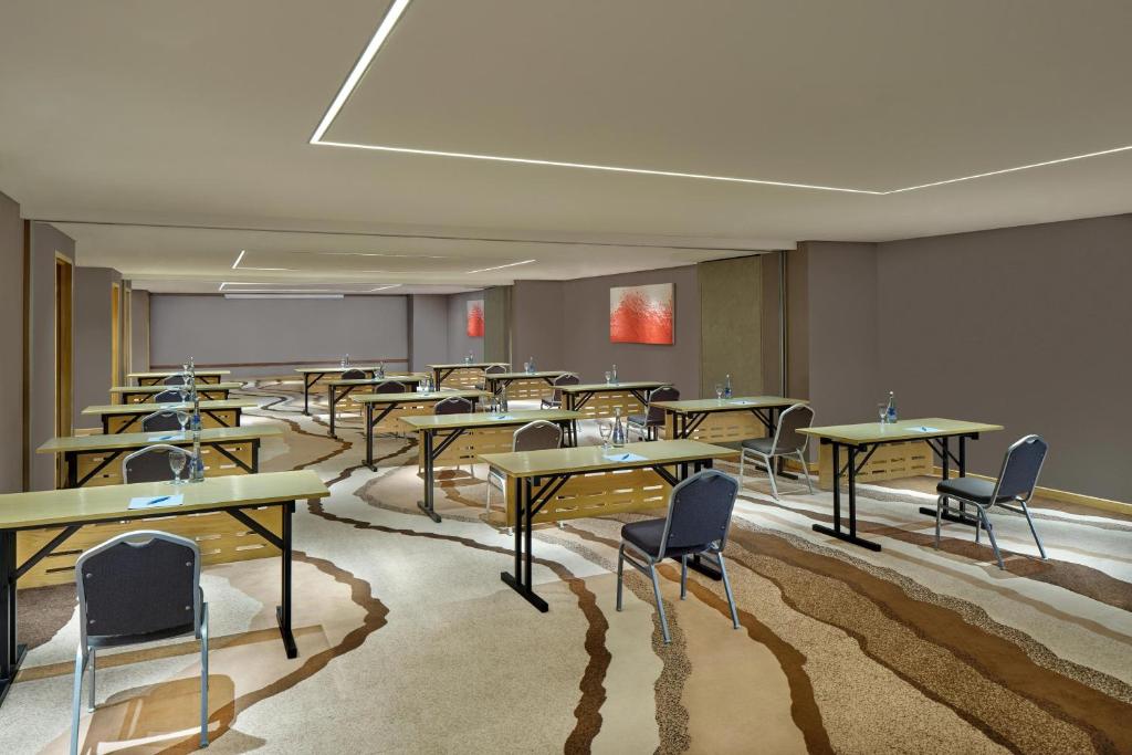 a classroom with tables and chairs in a room at Four Points by Sheraton Balikpapan in Balikpapan