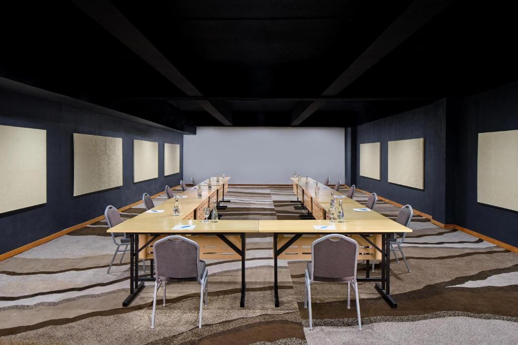 a large conference room with a long table and chairs at Four Points by Sheraton Balikpapan in Balikpapan