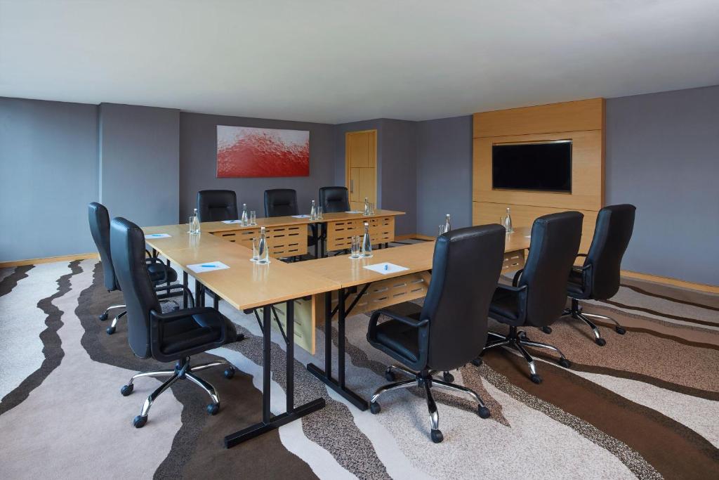 a conference room with a long table and chairs at Four Points by Sheraton Balikpapan in Balikpapan