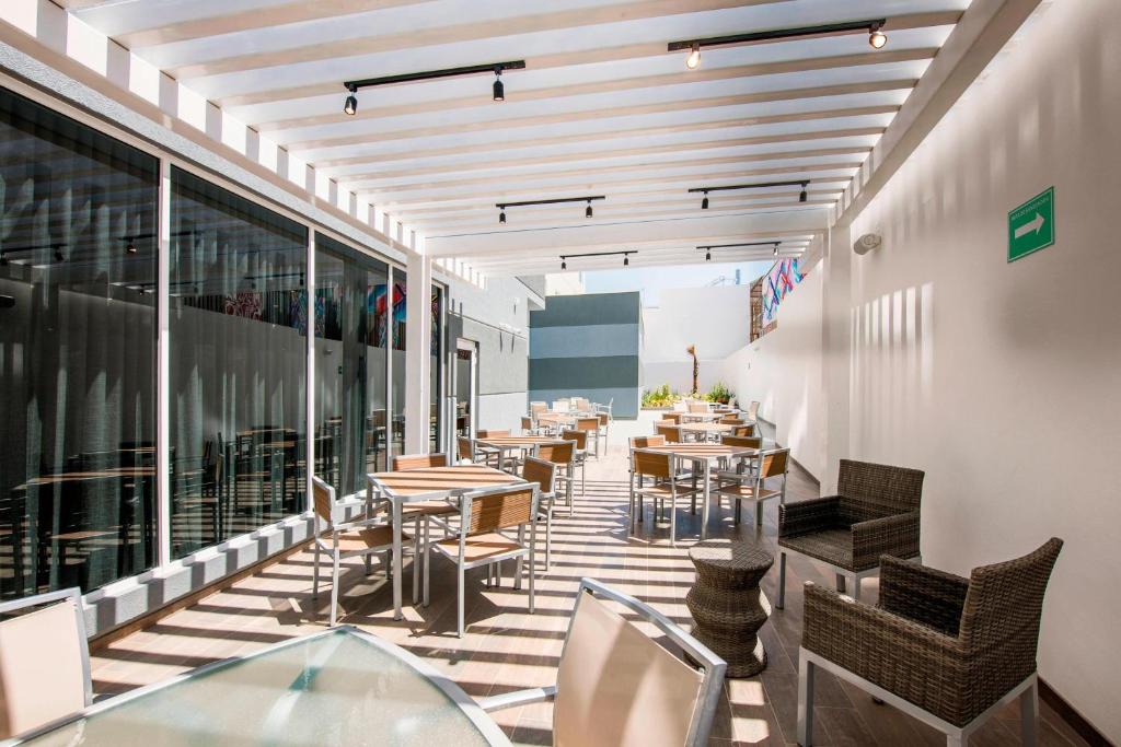 a restaurant with tables and chairs on a balcony at Fairfield Inn & Suites by Marriott Tijuana in Tijuana