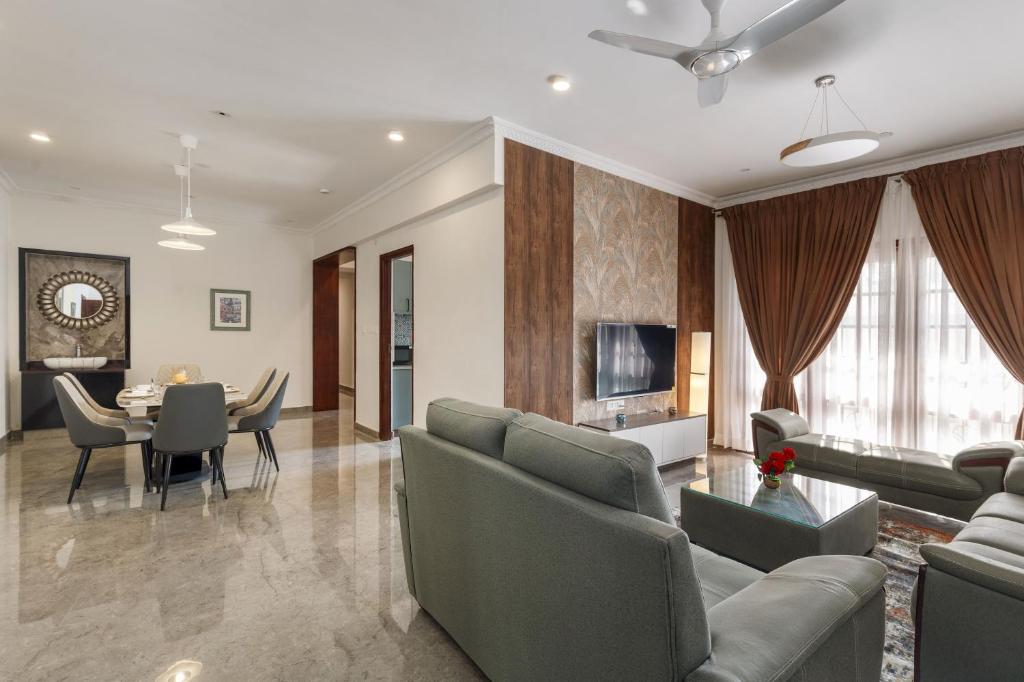 a living room with a couch and a table at Emerlad Apartment 201 Nr MG Road Housekeeping in Bengaluru