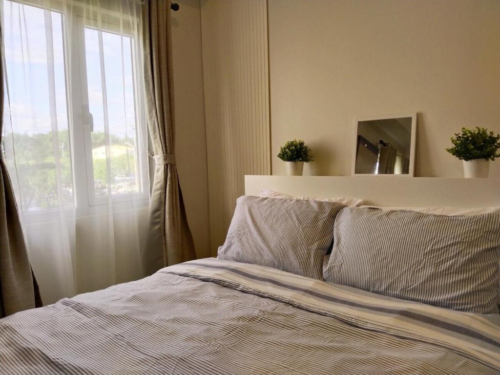 Postel nebo postele na pokoji v ubytování APT at G-207 in SMDC Cheer Residences