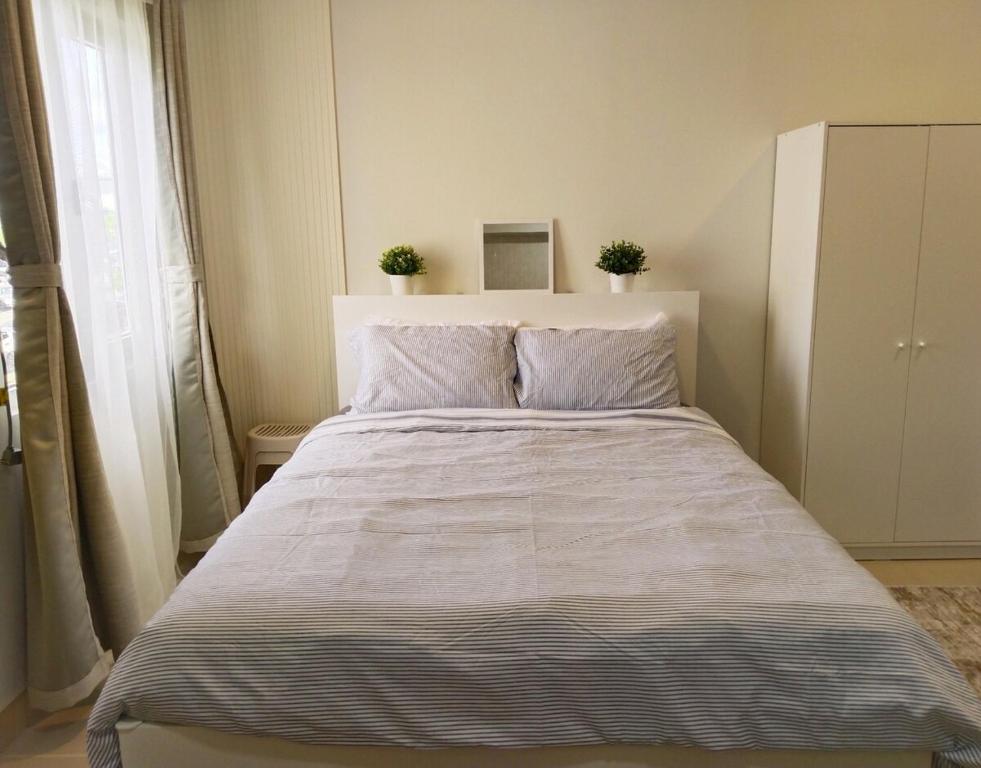 Postel nebo postele na pokoji v ubytování APT at G-207 in SMDC Cheer Residences