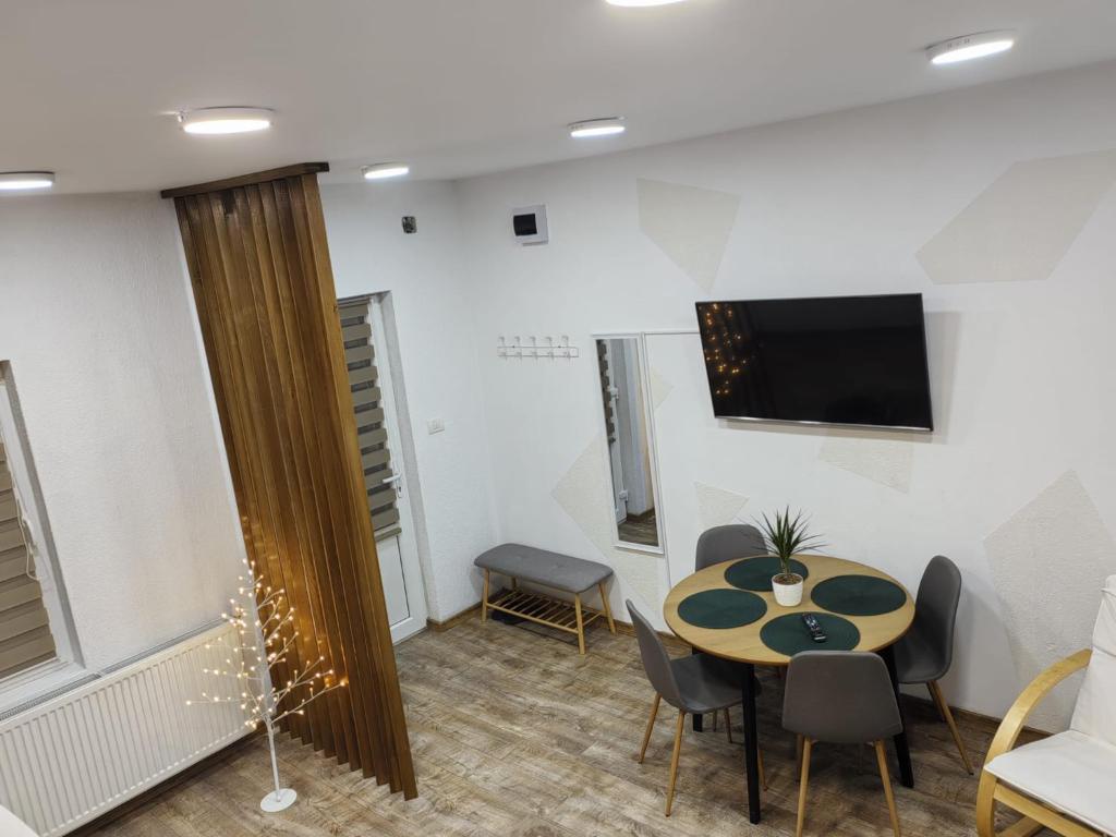 ボルセックにあるCasa Orhideeaのテーブルと椅子とテレビのある部屋