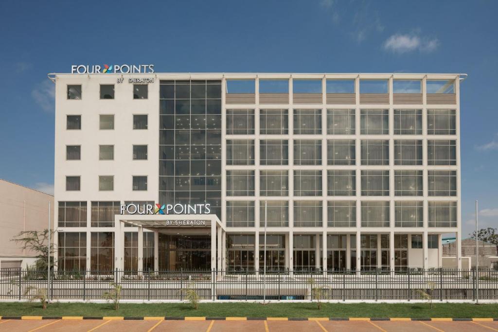 a large white building with a sign on it at Four Points by Sheraton Nairobi Airport in Nairobi