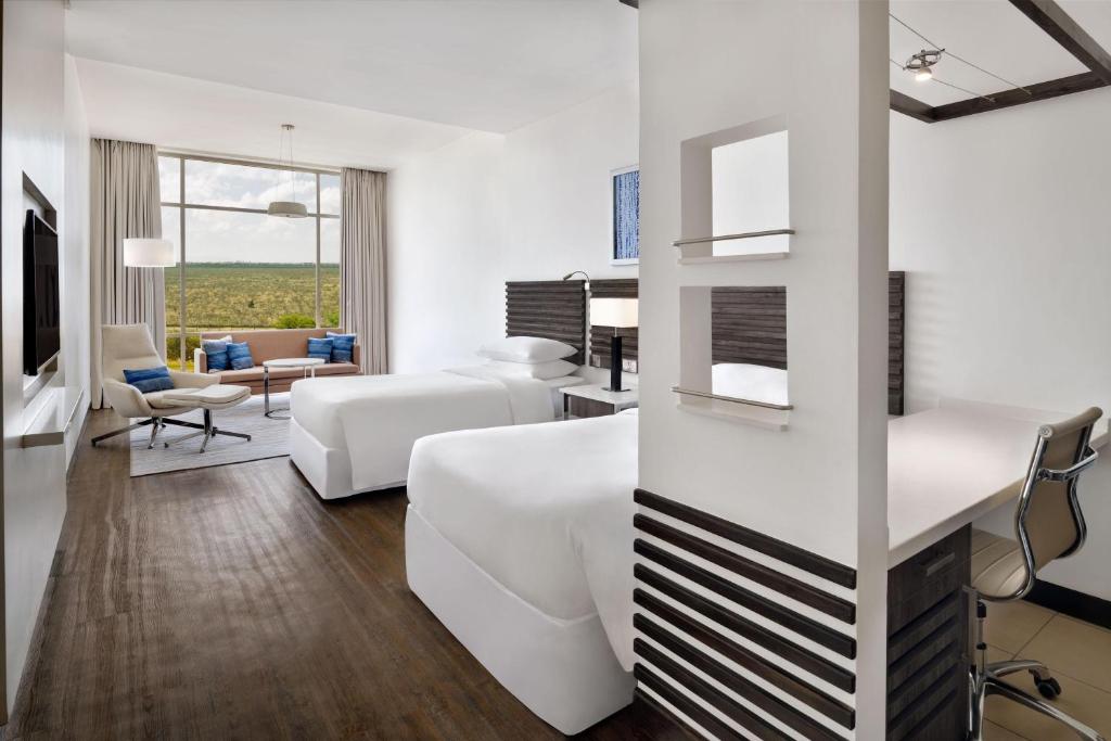 a living room with white furniture and a couch at Four Points by Sheraton Nairobi Airport in Nairobi