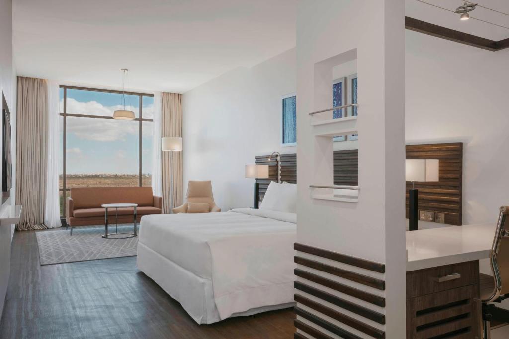 a hotel room with a bed and a living room at Four Points by Sheraton Nairobi Airport in Nairobi