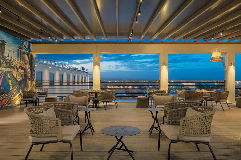 a restaurant with chairs and tables and a view of the ocean at Four Points by Sheraton Nairobi Airport in Nairobi