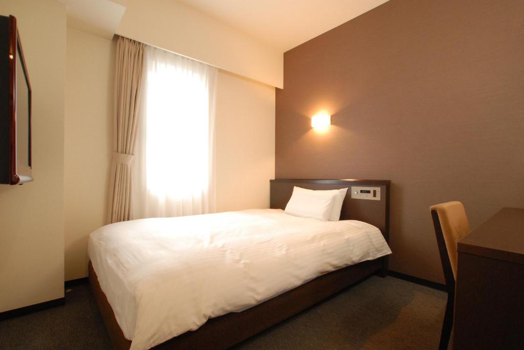Postel nebo postele na pokoji v ubytování AB Hotel Okazaki