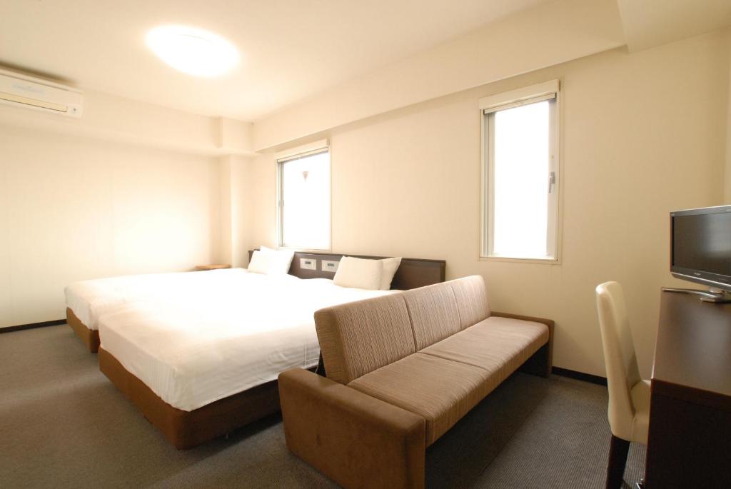 Postel nebo postele na pokoji v ubytování AB Hotel Okazaki