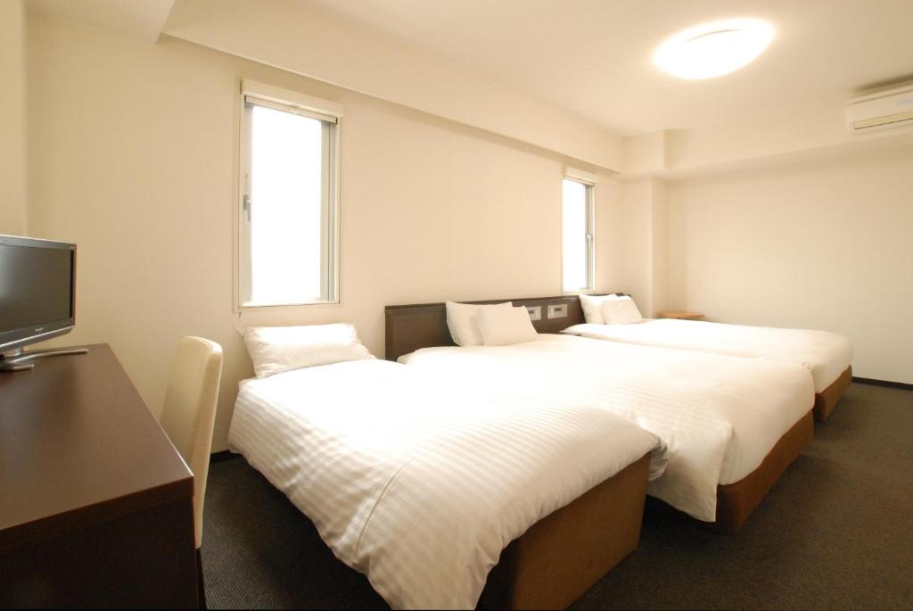Postel nebo postele na pokoji v ubytování AB Hotel Okazaki