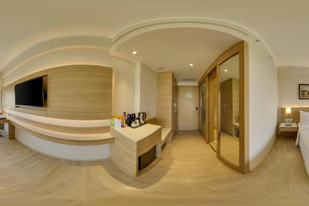 a hotel room with a reception desk and a bed at Fairfield by Marriott Lucknow in Lucknow