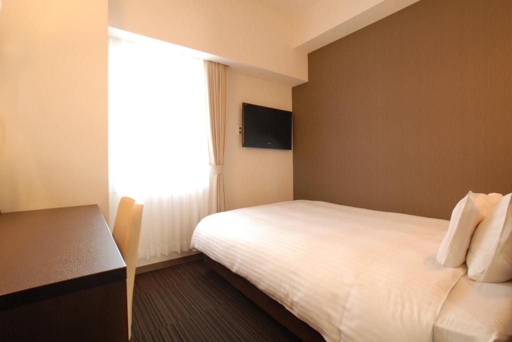 Postel nebo postele na pokoji v ubytování AB Hotel Komaki