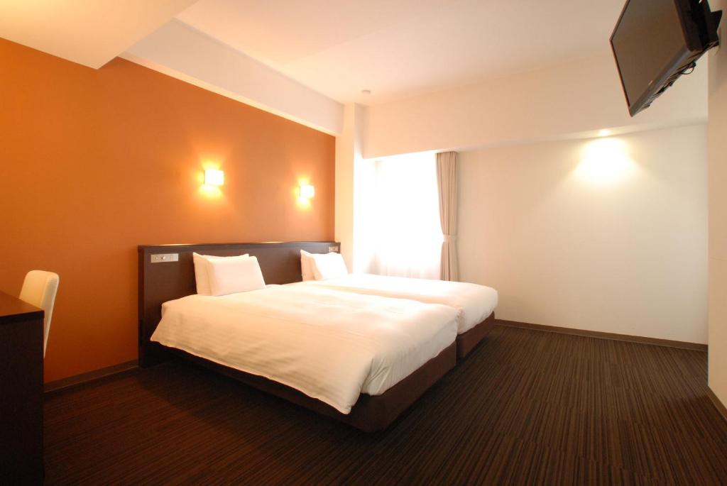Postel nebo postele na pokoji v ubytování AB Hotel Komaki