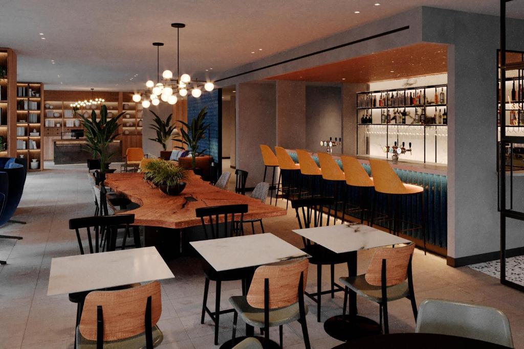 a restaurant with tables and chairs and a bar at Four Points by Sheraton Matosinhos in Matosinhos