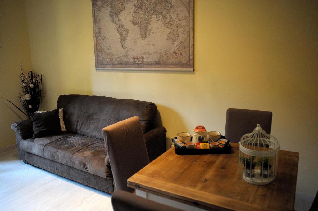 a living room with a couch and a wooden table at Aquarius Inn in Rome