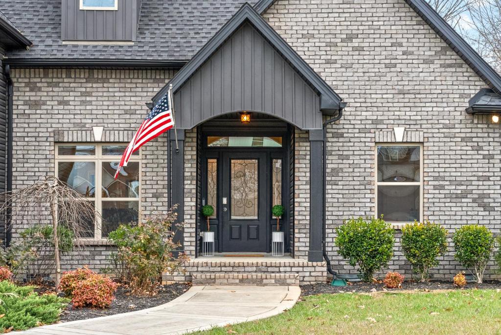 a house with an american flag in front of it at The Clubhouse on Colston, by Byers & Harvey in Clarksville