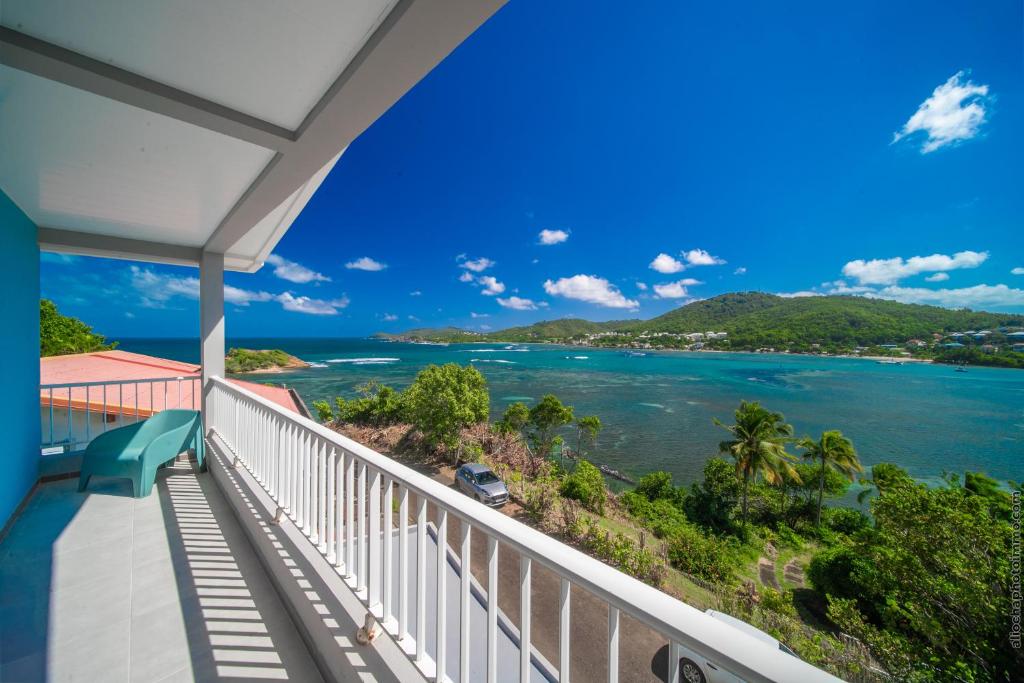 a view of the ocean from the balcony of a house at Sublime Villa Piscine - Trésor de la Baie in La Trinité