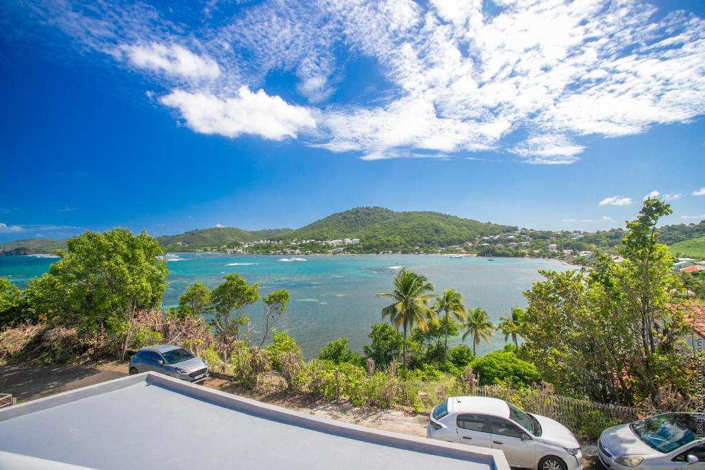 a view of the ocean from a house at Sublime Villa Piscine - Trésor de la Baie in La Trinité