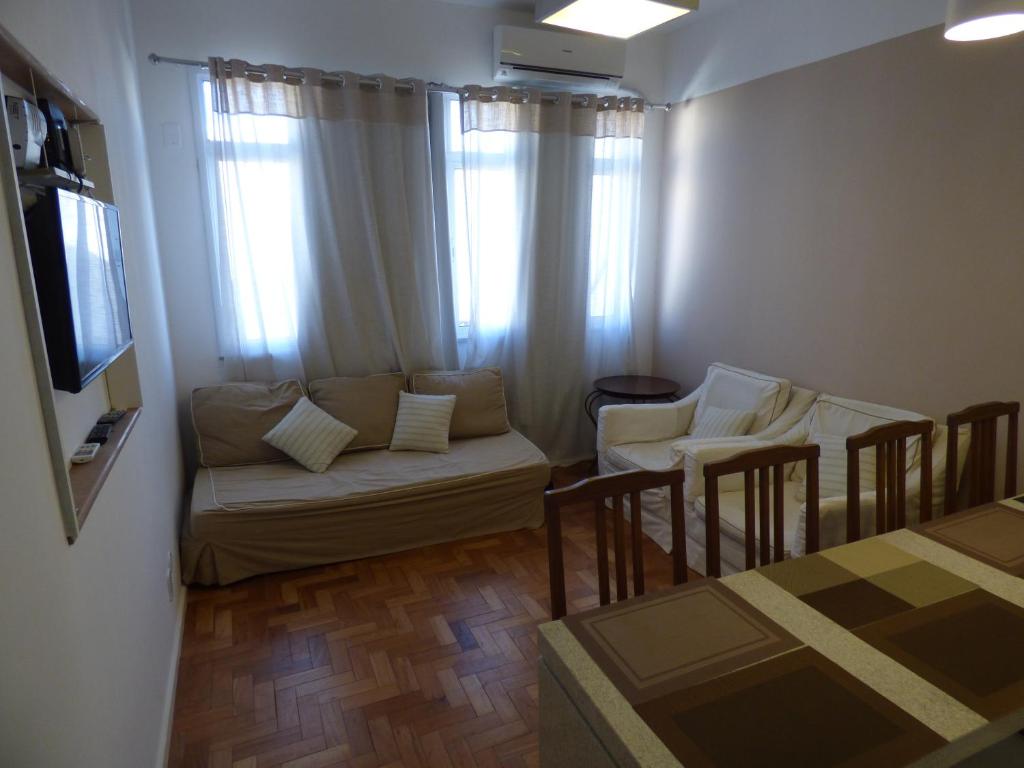 a living room with a couch and chairs and a television at Copacabana wonderful apartment in Rio de Janeiro