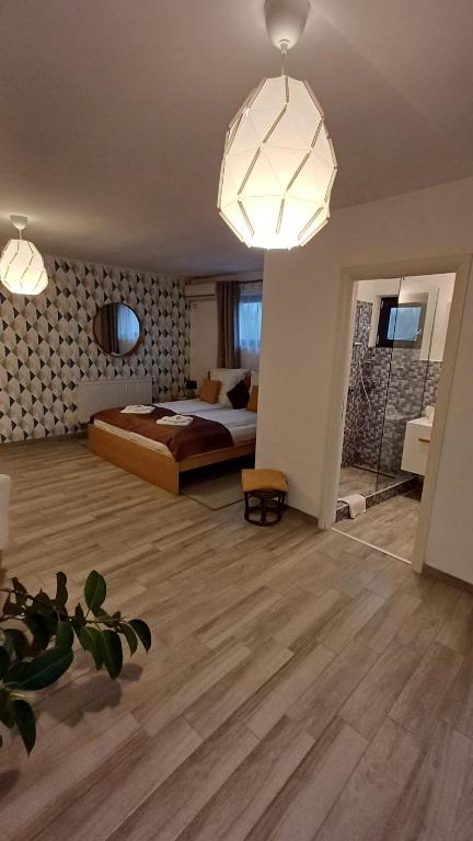a bedroom with a bed and two lights at Neferprod Apartments - IS - CAM 05 in Timişoara