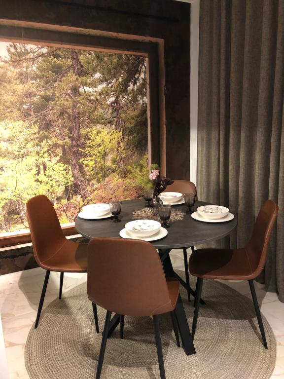 a dining room table with chairs and a large window at Premium City Center 2 rooms Apartment Glassed Balcony FREE PRIVATE PARKING in Kemi