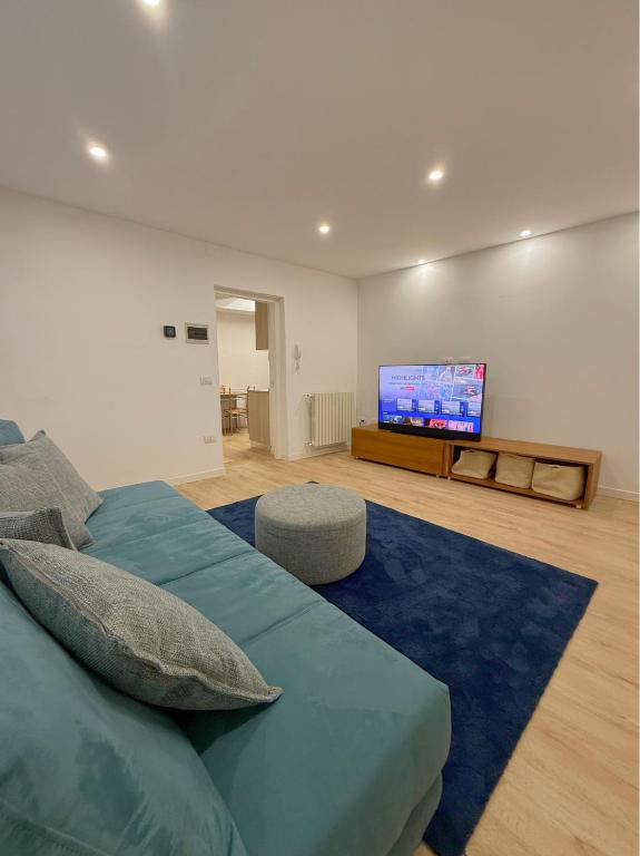 a bedroom with a bed and a flat screen tv at Lake Lovers House in Lesa