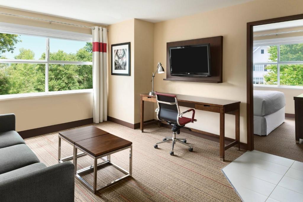 a hotel room with a desk and a bed at Four Points by Sheraton Surrey in Surrey
