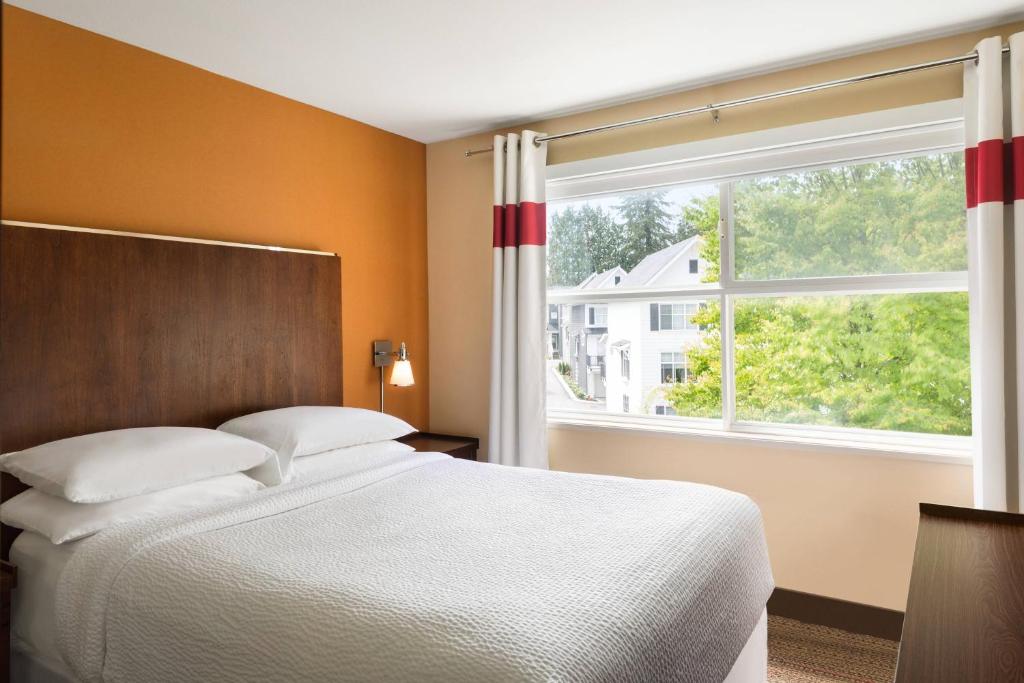 a bedroom with a bed and a large window at Four Points by Sheraton Surrey in Surrey