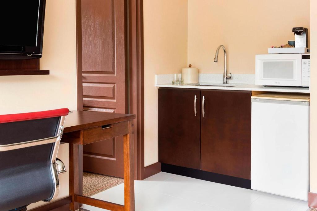 a small kitchen with a sink and a microwave at Four Points by Sheraton Surrey in Surrey
