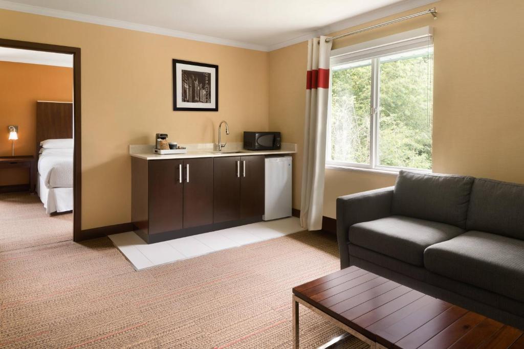 a living room with a couch and a sink at Four Points by Sheraton Surrey in Surrey
