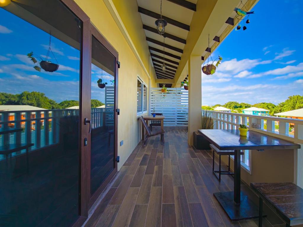 a balcony with a table and a view at Louis' Apartments in Placencia