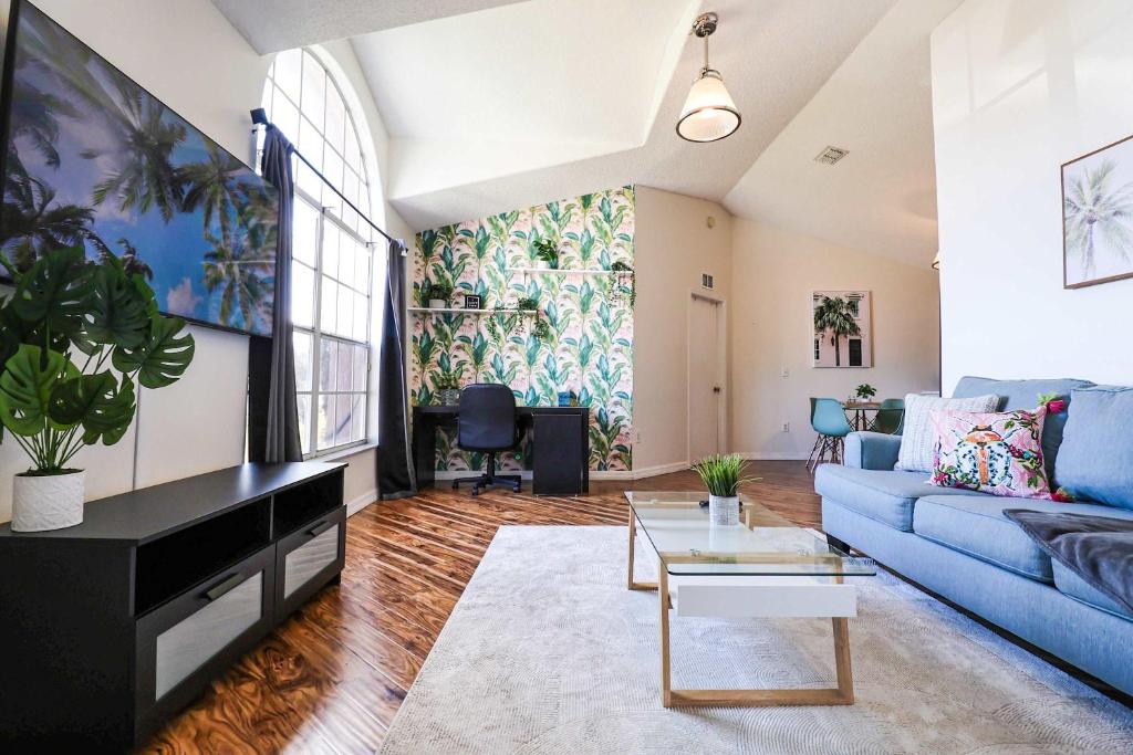 a living room with a blue couch and a table at New APT 15Min Drive Disney and Airport - Parks KingBed Pets in Kissimmee