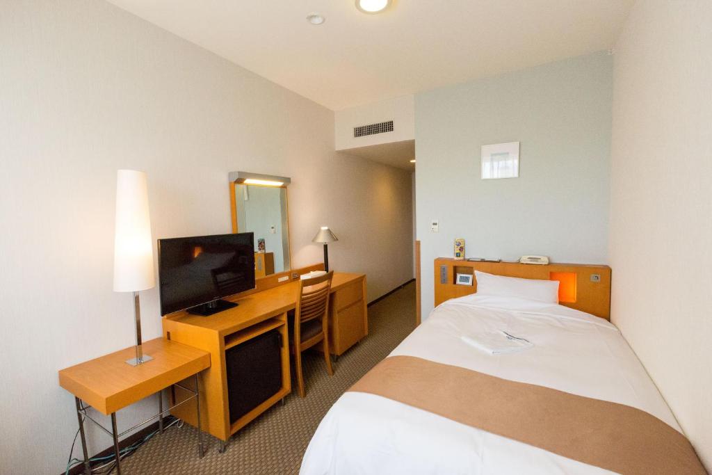 Postel nebo postele na pokoji v ubytování Keisei Hotel Miramare