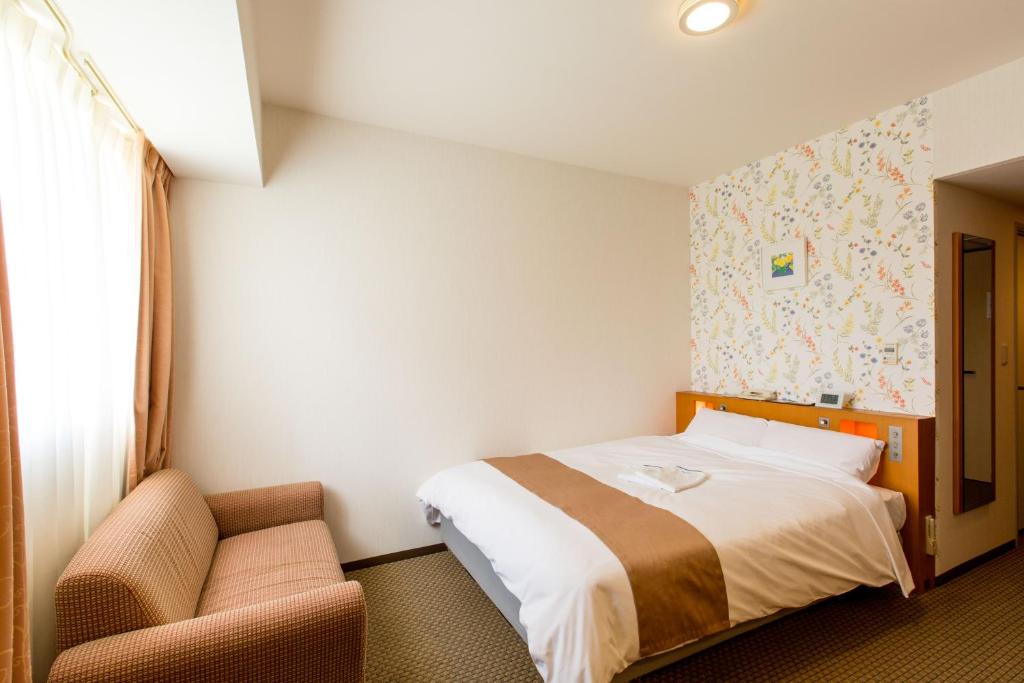 Postel nebo postele na pokoji v ubytování Keisei Hotel Miramare