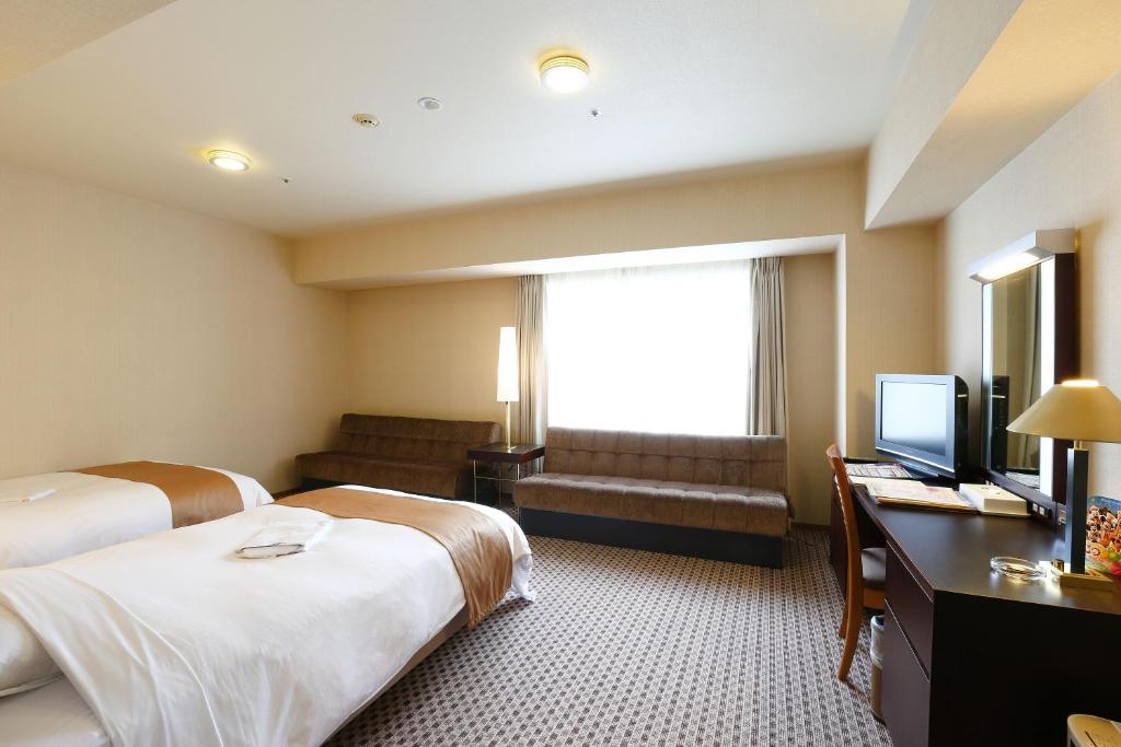 Postel nebo postele na pokoji v ubytování Keisei Hotel Miramare