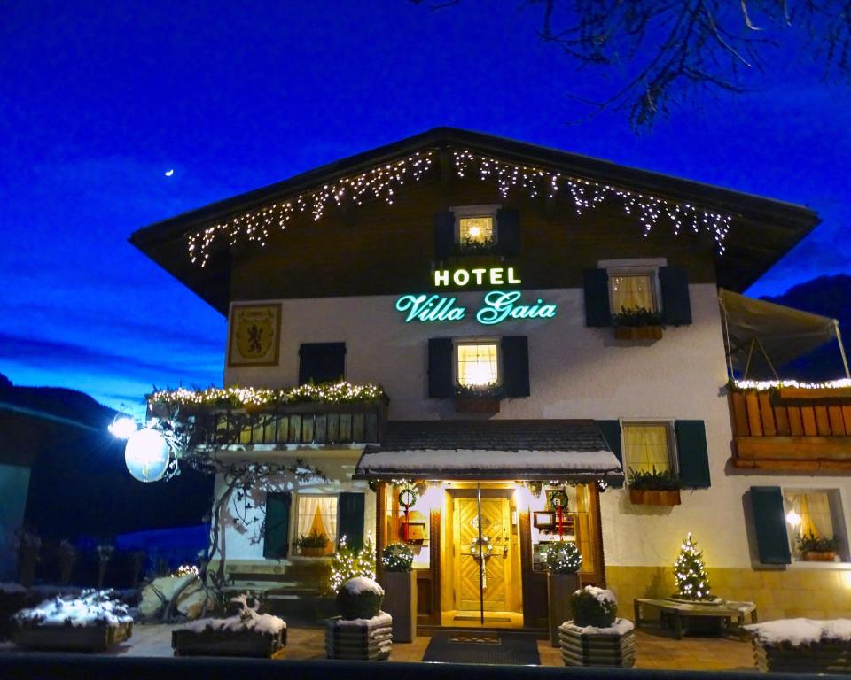 a restaurant with a large clock on the front of it at Hotel Villa Gaia in Cortina dʼAmpezzo