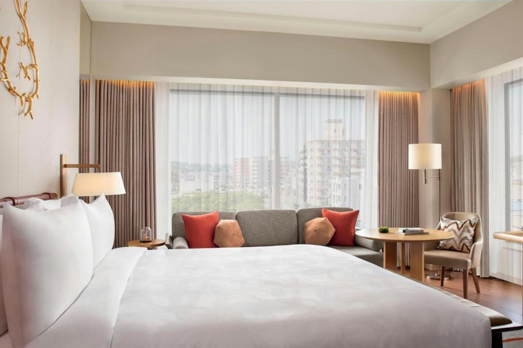 a hotel room with a large bed and a couch at JW Marriott Hotel Nara in Nara