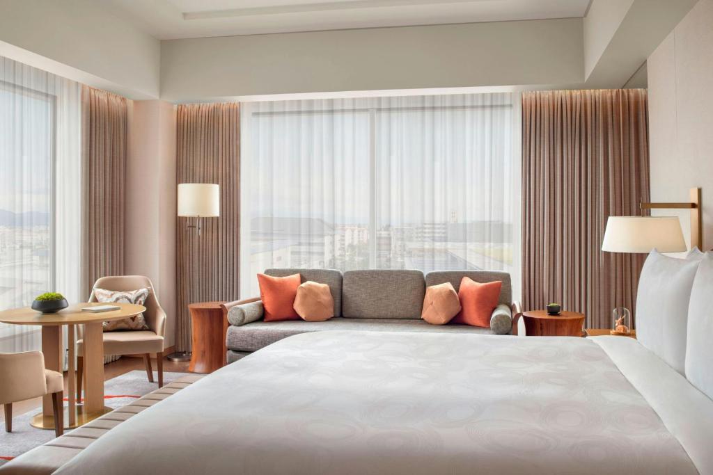 a hotel room with a large bed and a couch at JW Marriott Hotel Nara in Nara