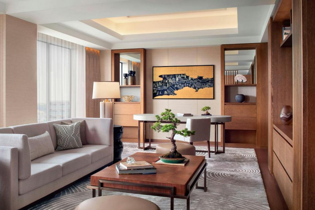 a living room with a couch and a table at JW Marriott Hotel Nara in Nara