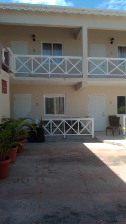 a large house with a balcony and a porch at Paradise Beach Hotel in Kingstown