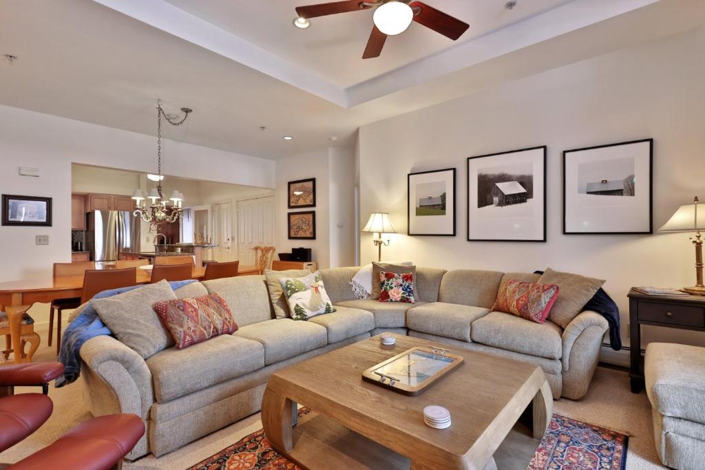 a living room with a couch and a table at Lodges at Sunrise 3BR 3BA Luxury Ski On Ski Off Condo, Pool, Hot Tub, Gym, Sports Center in Killington