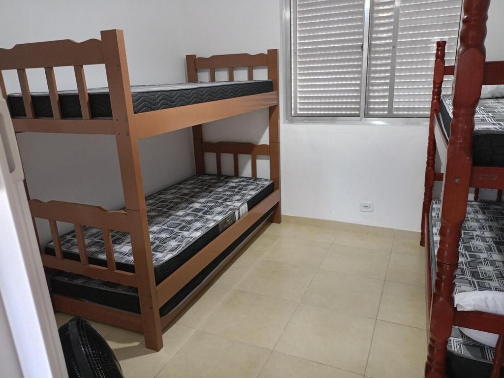 a room with two bunk beds and a window at apartment 1 bedroom in Mongaguá